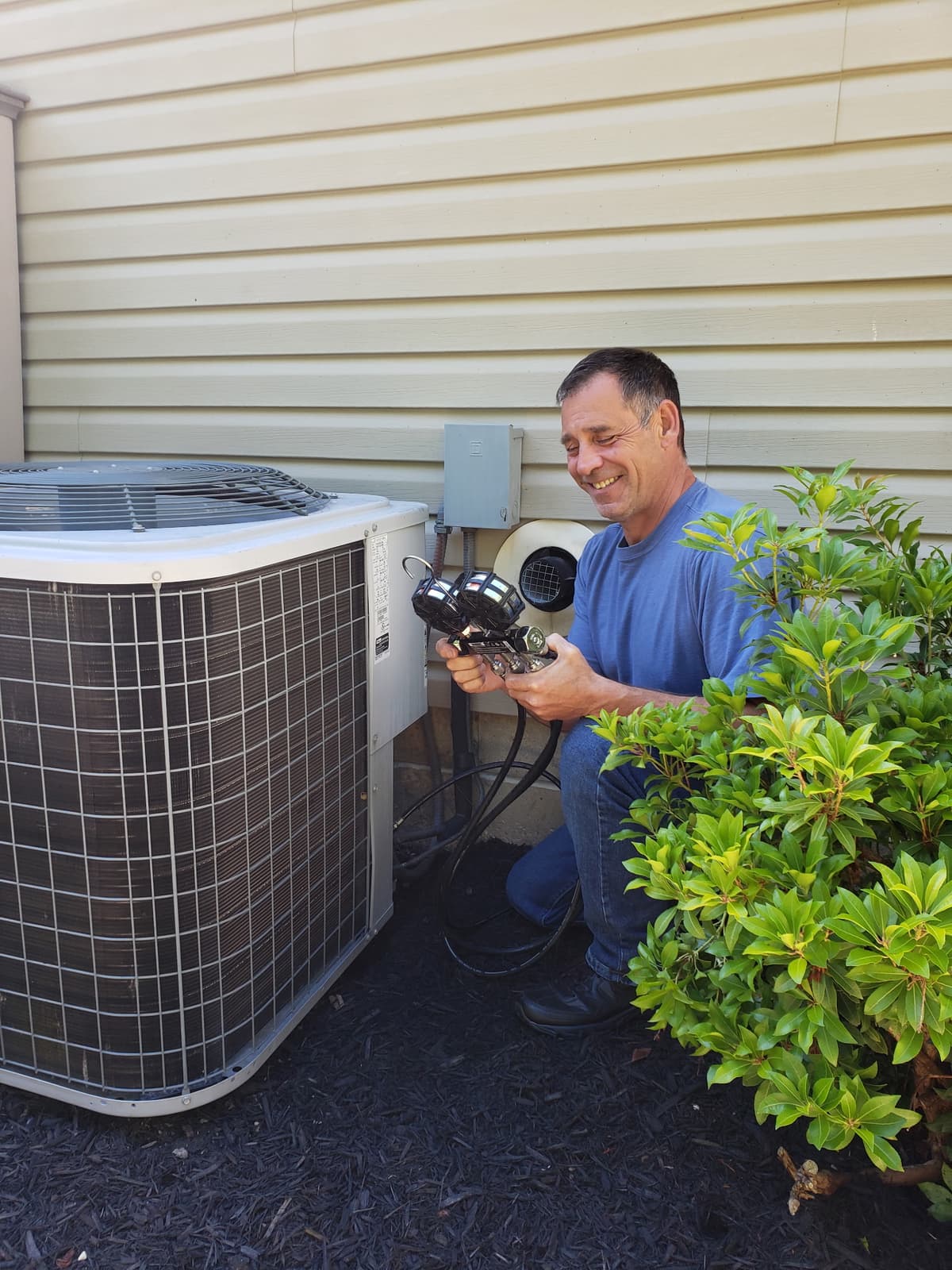 Tom Torrance working on an AC unit - Your local HVAC expert in Erie County
